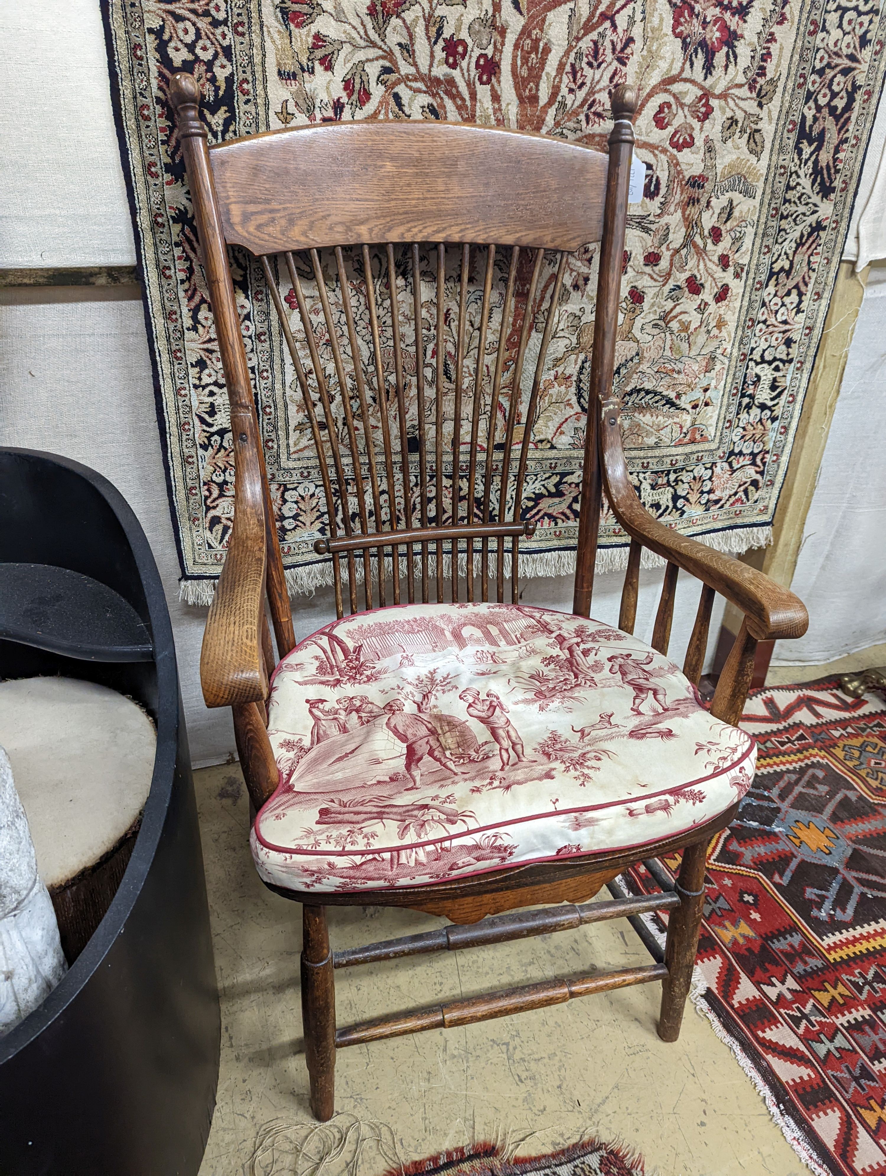 An early 20th century oak and beech American spindle-back elbow chair, width 60cm, depth 45cm, height 112cm